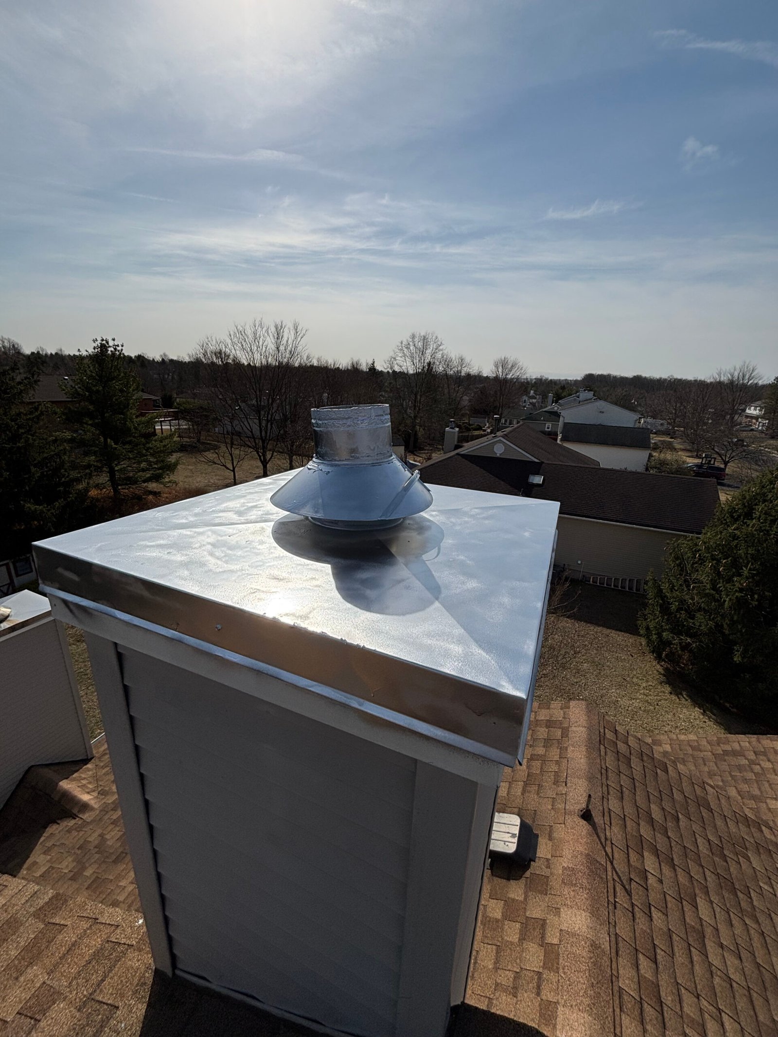 "An expert chimney sweep carefully cleaning a brick chimney."